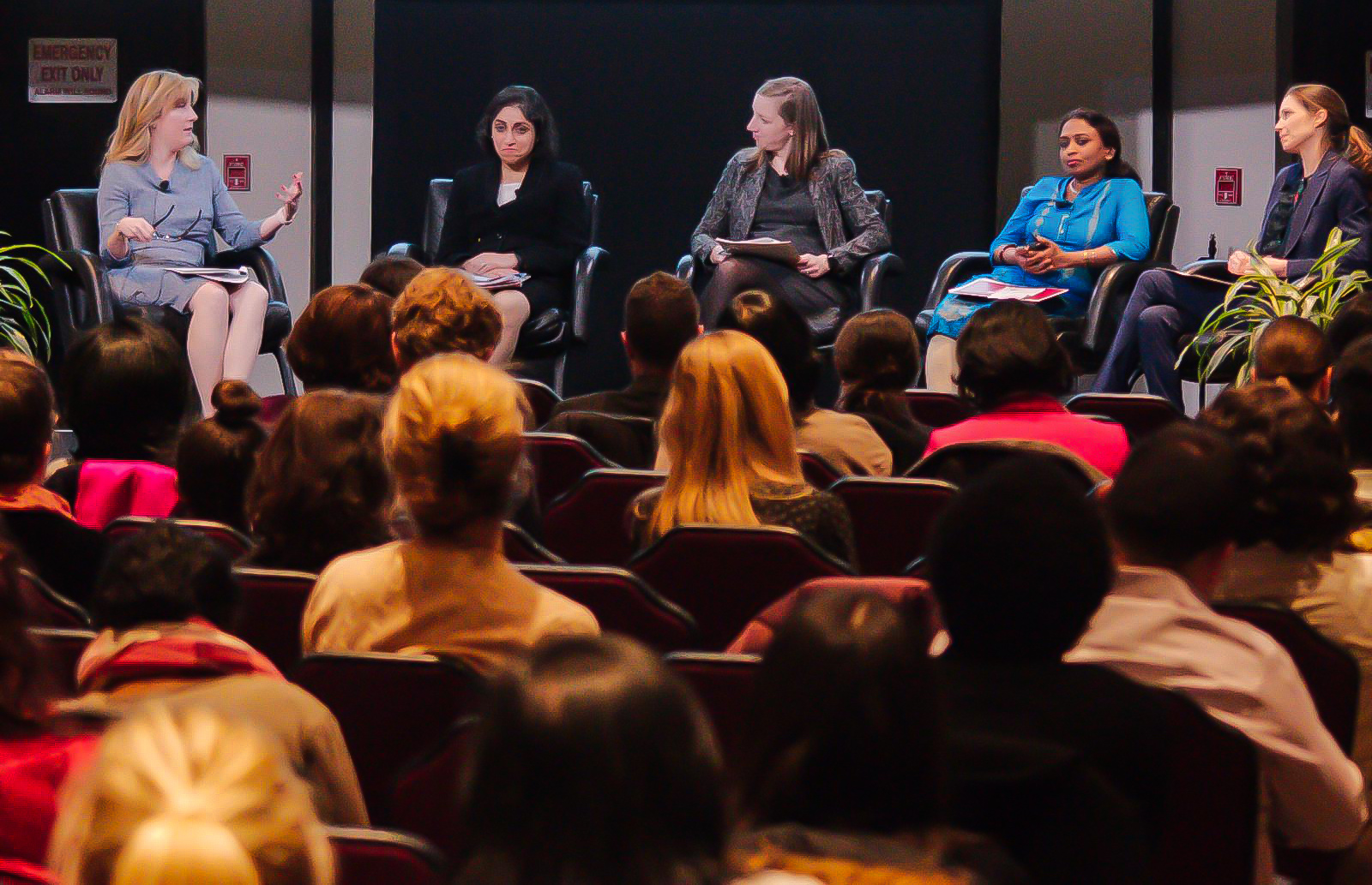 Panel of women speaking at a conference.